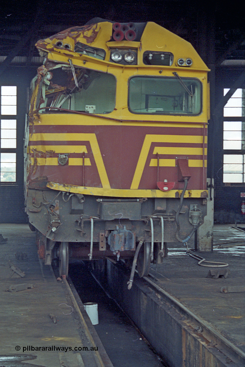 192-02
Junee, NSWSRA standard gauge locomotive depot, front view of accident damaged NSWGR 80 class unit 8020 inside the roundhouse. An ALCo CE615A model with Mitsubishi electrics built by Comeng NSW in 1979 serial C6106-20.
Keywords: 80-class;8020;Comeng-NSW;ALCo;CE615A;C6106-20;