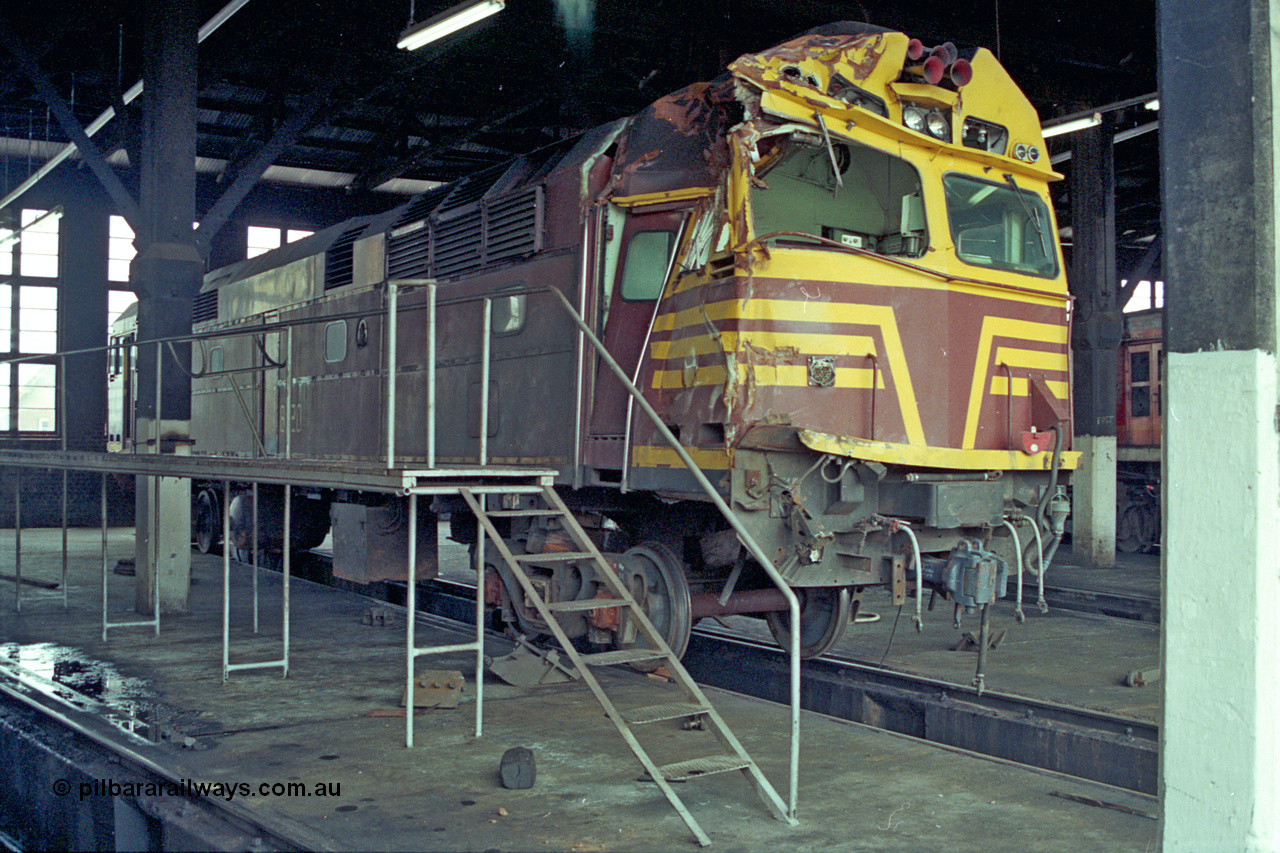 192-03
Junee, NSWSRA standard gauge locomotive depot, accident damaged NSWGR 80 class unit 8020 inside the roundhouse. An ALCo CE615A model with Mitsubishi electrics built by Comeng NSW in 1979 serial C6106-20.
Keywords: 80-class;8020;Comeng-NSW;ALCo;CE615A;C6106-20;