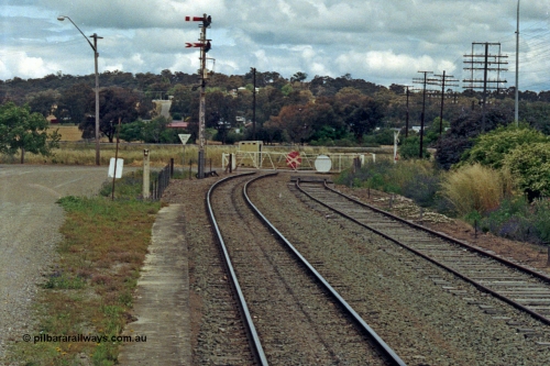 192-37
Cootamundra West, NSW, looking east in the up direction along South Fork, the truncated Tumut Siding is on the right, the Main South can be seen across the Yass Road non-interlocked hand gates with the top up semaphore signal operated by lever 45 and the lower arm controlled by Cootamundra North Signal Box.
