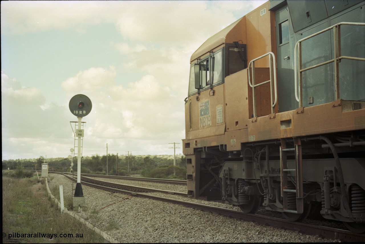 199-07
Meckering, National Rail NR class unit NR 19 Goninan built GE Cv40-9i model heads up train 7PM5 as it waits for a cross with the Prospector in the loop 1400 hrs 21st June 1997.
Keywords: NR-class;NR19;Goninan;GE;CV40-9i;7250-03/97-221;