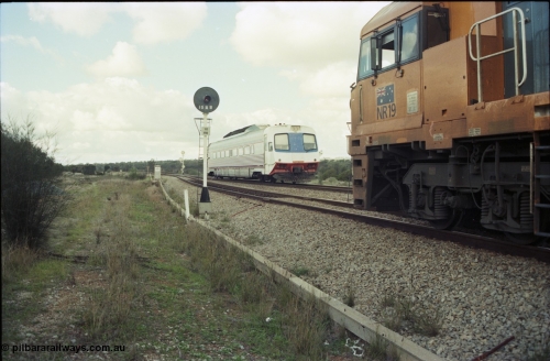 199-15
Meckering, Perth bound single Prospector car races along on the mainline as it crosses NR 19 on 7PM5 freighter.
Keywords: NR-class;NR19;Goninan;GE;CV40-9i;7250-03/97-221;