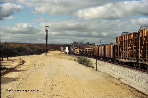 200-05
Moorine Rock, Westrail L class 271 Clyde Engineering EMD model GT26C serial 69-620 runs through the loop with the ballast cleaning train, known as the Circus Train while a Perth bound freighter sits in the mainline, June 22, 1997.
