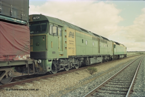 200-14
Moorine Rock, Australian National ALF class ALF 24 a Morrison Knudson rebuild of the AL class, new model being JT26C-2M and serial 94-AN-024, on the mainline with a Perth bound freight with AN class AN 6 Clyde Engineering EMD model JT46C serial 93-1302 on the lead June 22, 1997.
Keywords: ALF-class;ALF24;Morrison-Knudson;EMD;JT26C-2M;94-AN-024;rebuild;AL-class;AL22;JT26C;76-838;