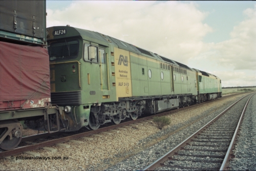 200-15
Moorine Rock, Australian National ALF class rebuild unit ALF 24, Morrison Knudson rebuilt the AL class into the ALF with the new model being JT26C-2M and serial 94-AN-024, on the mainline with a Perth bound freight with AN class AN 6 a Clyde Engineering built EMD model JT46C serial 93-1302 on the lead, June 22, 1997.
Keywords: ALF-class;ALF24;Morrison-Knudson;EMD;JT26C-2M;94-AN-024;rebuild;AL-class;AL22;JT26C;76-838;