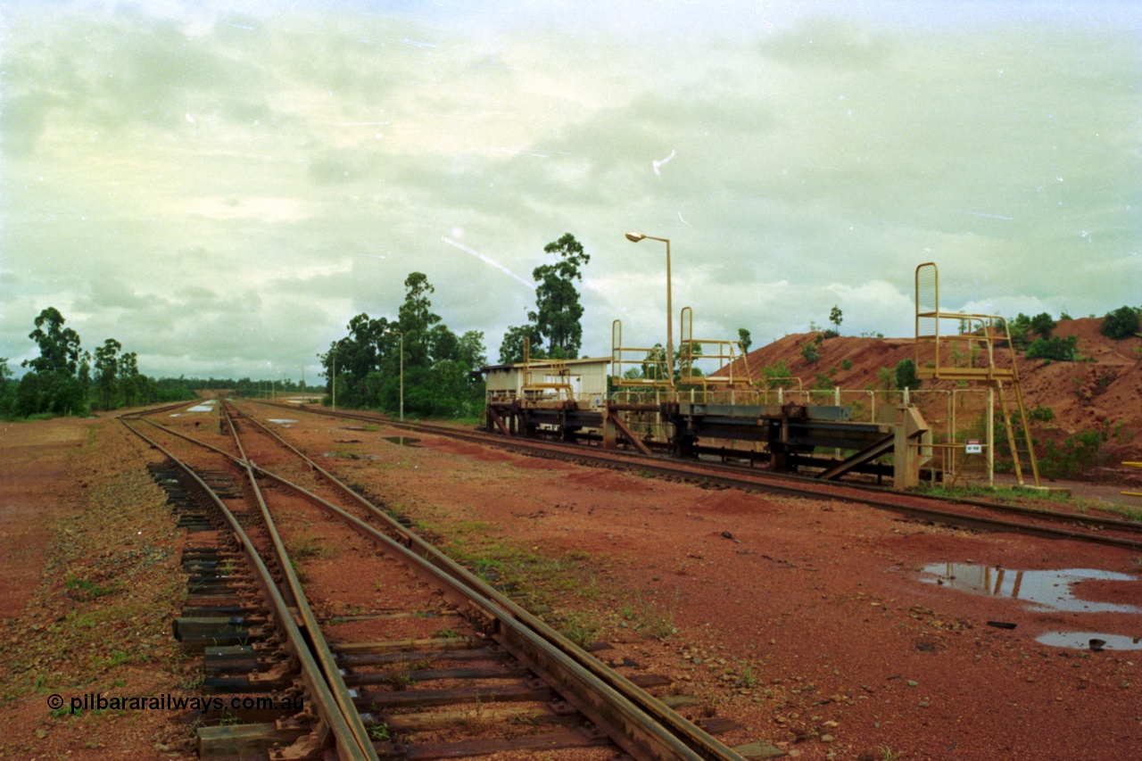 210-03
Weipa, Lorim Point, Comalco rail dump station, view of the hydraulic jacking or indexing arms located on the Andoom side of the unloader, used to position the train for unloading.
