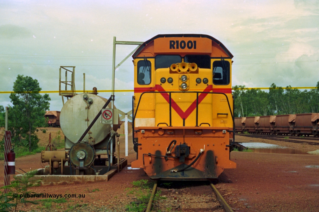 210-19
Weipa, Lorim Point, railway workshops, front view of Comalco R 1001 loco Clyde Engineering EMD model GT26C serial 72-752 while is sits at the fuel point, items of note are the second 'tropical roof' and the five chime horn cut into the nose. Also as the Weipa locomotives don't work in MU there is only the train brake hose and the main res hose for charging the belly dump discharge doors.
Keywords: R1001;Clyde-Engineering;EMD;GT26C;72-752;1.001;Comalco;