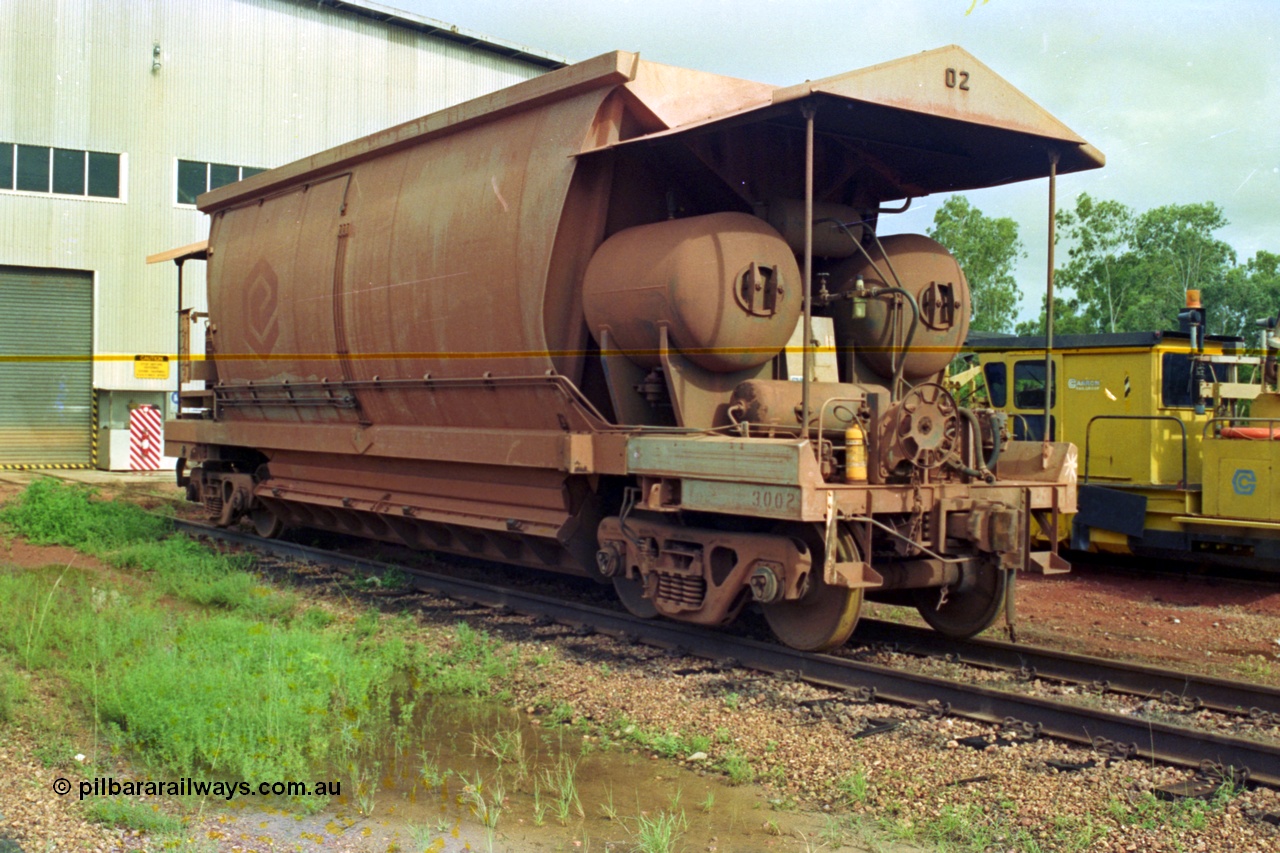 210-23
Weipa, Lorim Point railway workshops, side view of Comalco ore waggon 3002, shows handbrake, triple valve and piping, side piping and controls, bogies and discharge doors and air receivers, this is one of the compressor equipped waggons.
Keywords: HMAS-type;Comeng-Qld;Comalco;
