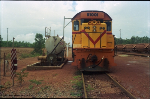 211-24
Weipa, Lorim Point railway workshops, front view of Comalco R 1001 loco Clyde Engineering EMD model GT26C serial 72-752 while is sits at the fuel point, items of note are the second 'tropical roof' and the five chime horn cut into the nose. Also as the Weipa locomotives don't work in MU there is only the train brake hose and the main res hose for charging the belly dump discharge doors.
Keywords: R1001;Clyde-Engineering;EMD;GT26C;72-752;1.001;Comalco;
