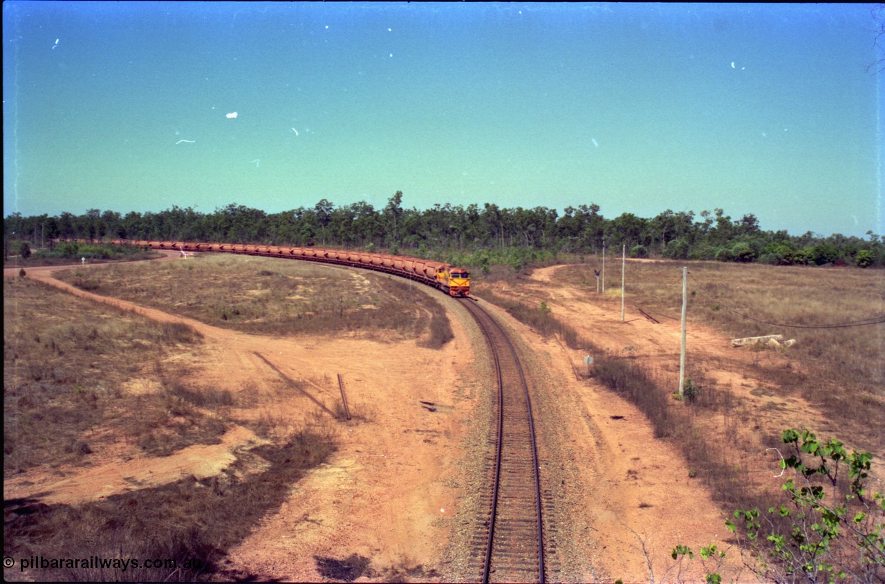 212-11
Weipa, a loaded train from Andoom Mine rounds the curve on approach to Lorim Point behind Comalco R 1004 Clyde Engineering EMD JT26C serial 90-1277 which is former Goldsworthy Mining loco GML 10.
Keywords: R1004;Clyde-Engineering-Kelso-NSW;EMD;JT26C;90-1277;Comalco;GML10;Cinderella;GML-class;
