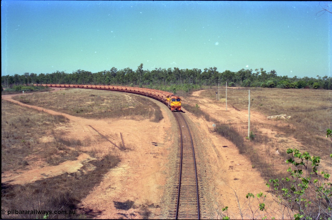 212-12
Weipa, a loaded train from Andoom Mine rounds the curve on approach to Lorim Point behind Comalco R 1004 Clyde Engineering EMD JT26C serial 90-1277 which is former Goldsworthy Mining loco GML 10.
Keywords: R1004;Clyde-Engineering-Kelso-NSW;EMD;JT26C;90-1277;Comalco;GML10;Cinderella;GML-class;