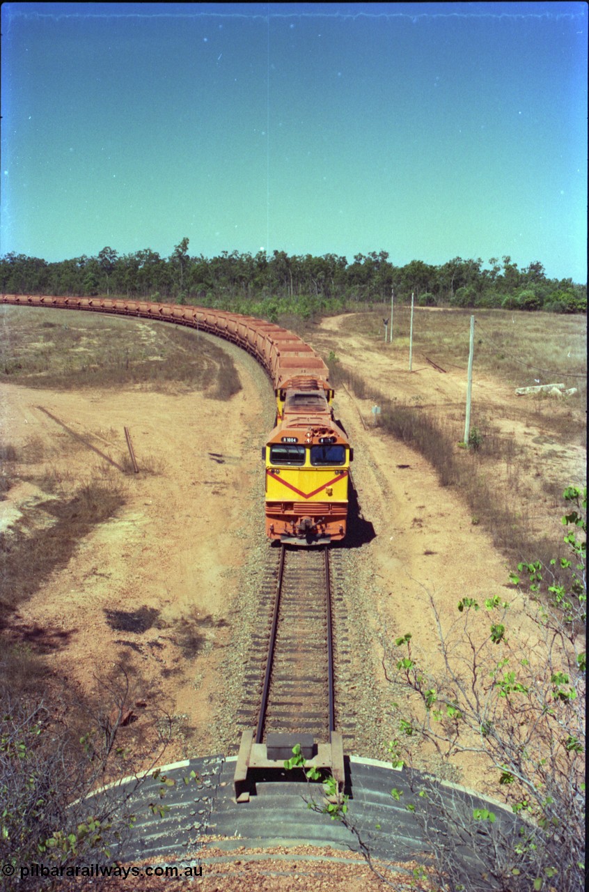 212-13
Weipa, a loaded train arrives back from Andoom Mine at the road overbridge at Lorim Point behind Comalco R 1004 Clyde Engineering EMD JT26C serial 90-1277 which is former Goldsworthy Mining loco GML 10.
Keywords: R1004;Clyde-Engineering-Kelso-NSW;EMD;JT26C;90-1277;Comalco;GML10;Cinderella;GML-class;