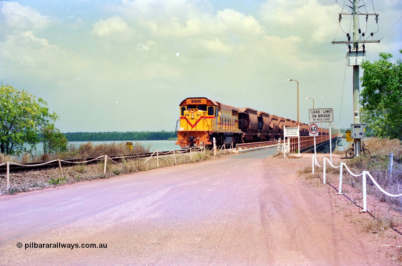 212-17
Comalco Clyde Engineering built EMD model GT26C unit R 1001 serial 72-752 originally numbered 1.001 and built in 1972 heads an empty train towards Andoom seen here coming off the Mission River Bridge at the 9 km. July 1995.
Keywords: R1001;Clyde-Engineering;EMD;GT26C;72-752;1.001;Comalco;