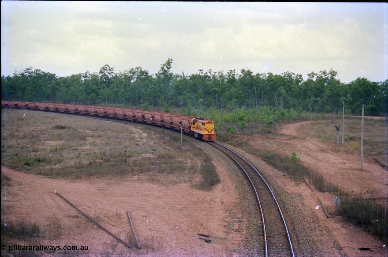 212-19
Weipa, a loaded train from Andoom Mine rounds the curve on approach to Lorim Point behind a long end leading Comalco R 1001 Clyde Engineering built EMD model GT26C serial 72-752 originally numbered 1.001 and built in 1972. July 1995.
Keywords: R1001;Clyde-Engineering;EMD;GT26C;72-752;1.001;Comalco;