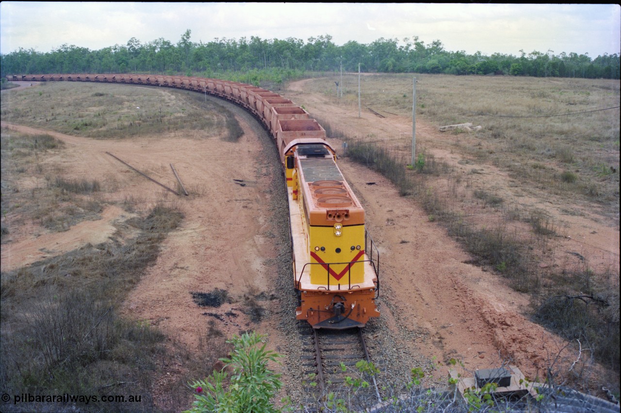 212-21
Weipa, a loaded train from Andoom Mine rounds the curve on approach to Lorim Point behind a long end leading Comalco R 1001 Clyde Engineering built EMD model GT26C serial 72-752 originally numbered 1.001 and built in 1972. July 1995.
Keywords: R1001;Clyde-Engineering;EMD;GT26C;72-752;1.001;Comalco;
