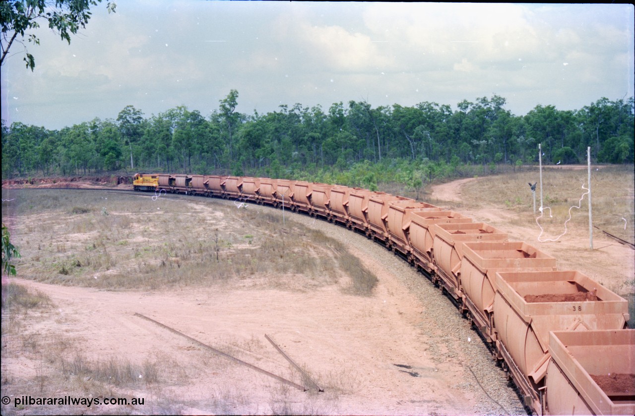 212-26
Weipa, empty train departs Lorim Point around the curve with another run to the mine at Andoom behind Comalco R 1001 Clyde Engineering built EMD model GT26C serial 72-752 originally numbered 1.001 and built in 1972. July 1995.

