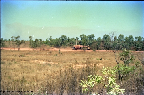 212-04
Weipa, Lorim Point, view of articulated haulpak on haul road from overbridge.
