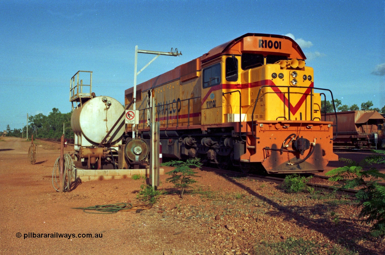 213-17
Weipa, Lorim Point workshops, Comalco R 1001 loco Clyde Engineering built EMD model GT26C serial 72-752 sits at the fuel point, items of note are these units were setup to have the long hood leading, the second 'tropical roof' and the five chime horn cut into the nose. Also noticeable, the units don't have dynamic brakes fitted so there is no brake 'blister' in the middle of the hood like you see on the GT26C models of WAGR L or VR C classes.
Keywords: R1001;Clyde-Engineering;EMD;GT26C;72-752;1.001;Comalco;