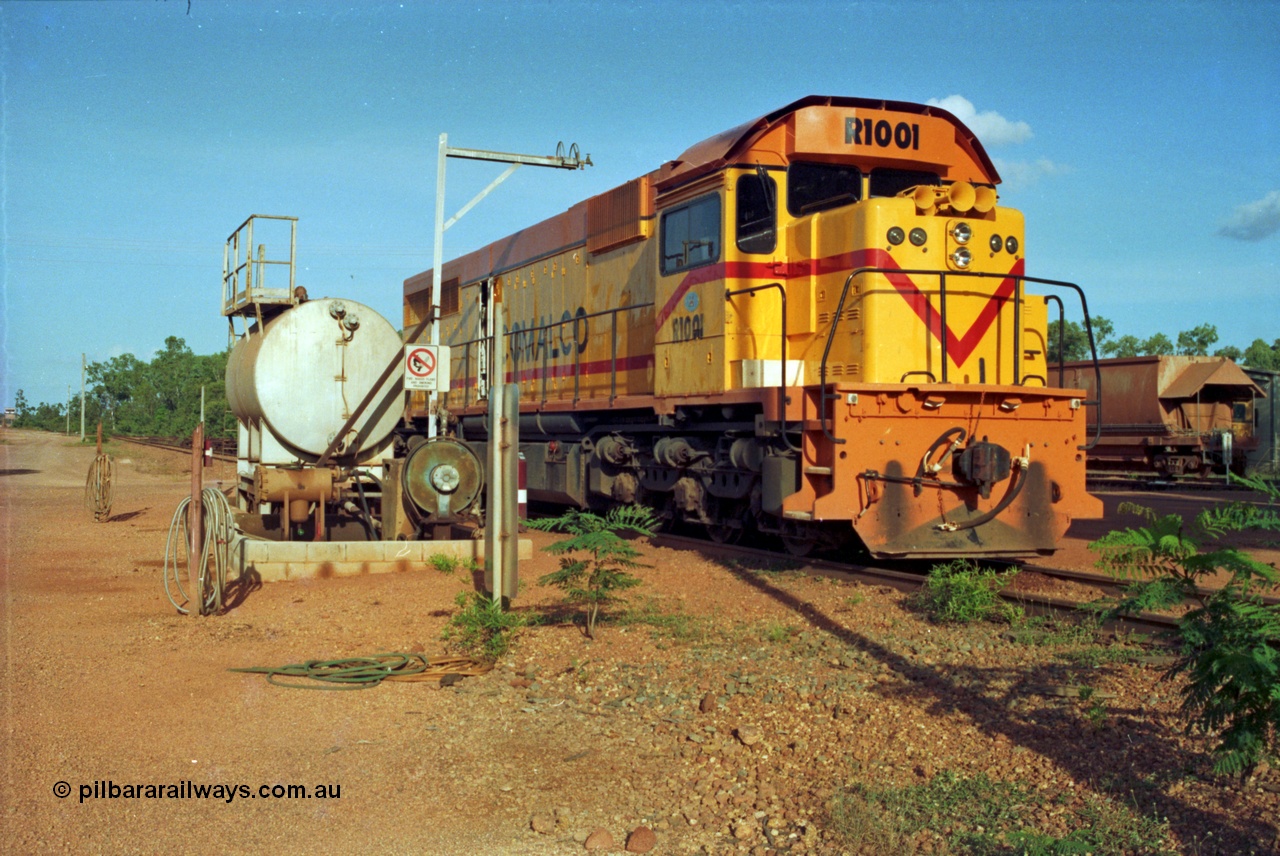 213-18
Weipa, Lorim Point workshops, Comalco R 1001 loco Clyde Engineering built EMD model GT26C serial 72-752 sits at the fuel point, items of note are these units were setup to have the long hood leading, the second 'tropical roof' and the five chime horn cut into the nose. Also noticeable, the units don't have dynamic brakes fitted so there is no brake 'blister' in the middle of the hood like you see on the GT26C models of WAGR L or VR C classes.
Keywords: R1001;Clyde-Engineering;EMD;GT26C;72-752;1.001;Comalco;