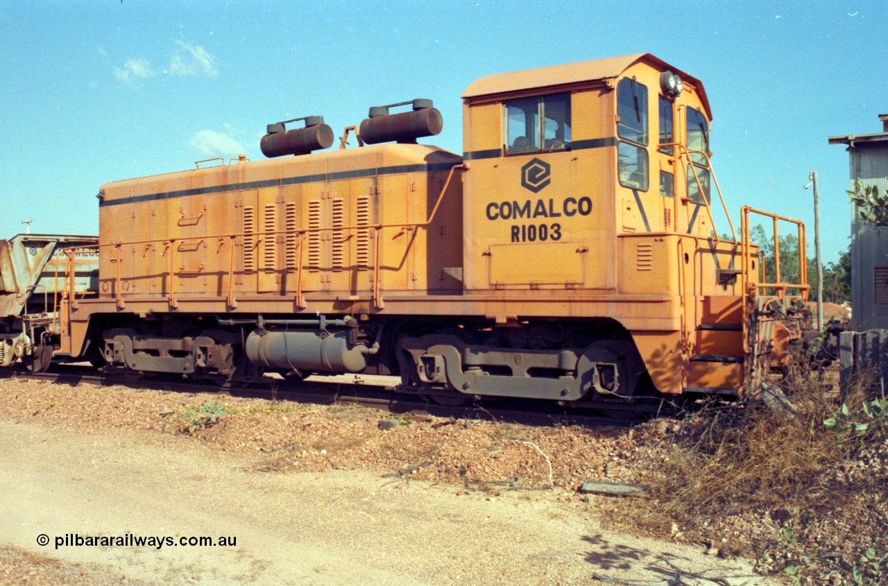 213-26
Weipa, Lorim Point railway workshops. Comalco shunt engine R 1003 coupled to a Difco side dump waggon. R 1003 is an Electro Motive built NW2 model with serial number 4114 and frame number of E761-8 was built in November 1946 at La Grange originally for Canadian National with road number 7943. Sold to Comalco in December 1975 and entered service in 1976. This unit was subsequently scrapped in 2000.
Keywords: R1003;EMD;NW2;4114;E761-8;Comalco;Canadian-National;