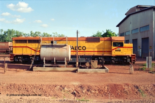 213-05
Weipa, Lorim Point fuel point looking south across the apron, Comalco R 1001 loco Clyde Engineering built EMD model GT26C serial 72-752 sits at the fuel point, items of note are these units were setup to have the long hood leading, the second 'tropical roof' and the five chime horn cut into the nose. Also noticeable, the units don't have dynamic brakes fitted so there is no brake 'blister' in the middle of the hood like you see on the GT26C models of WAGR L or VR C classes. September 1995.
Keywords: R1001;Clyde-Engineering;EMD;GT26C;72-752;1.001;Comalco;
