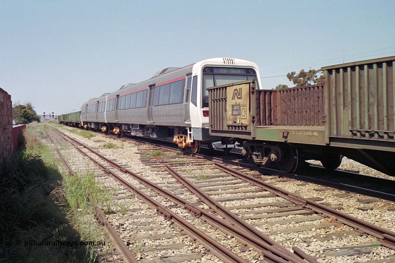 215-13
Peterborough, a new Perth electric suburban A Set being transported across the country on the rear of an SP service, AEA class AEA 220 and an AEB, built by Walkers Limited in Maryborough, Qld. The narrow gauge power bogies are in the following open waggon.
Keywords: A-class;AEA220;Walkers-Ltd-Qld;