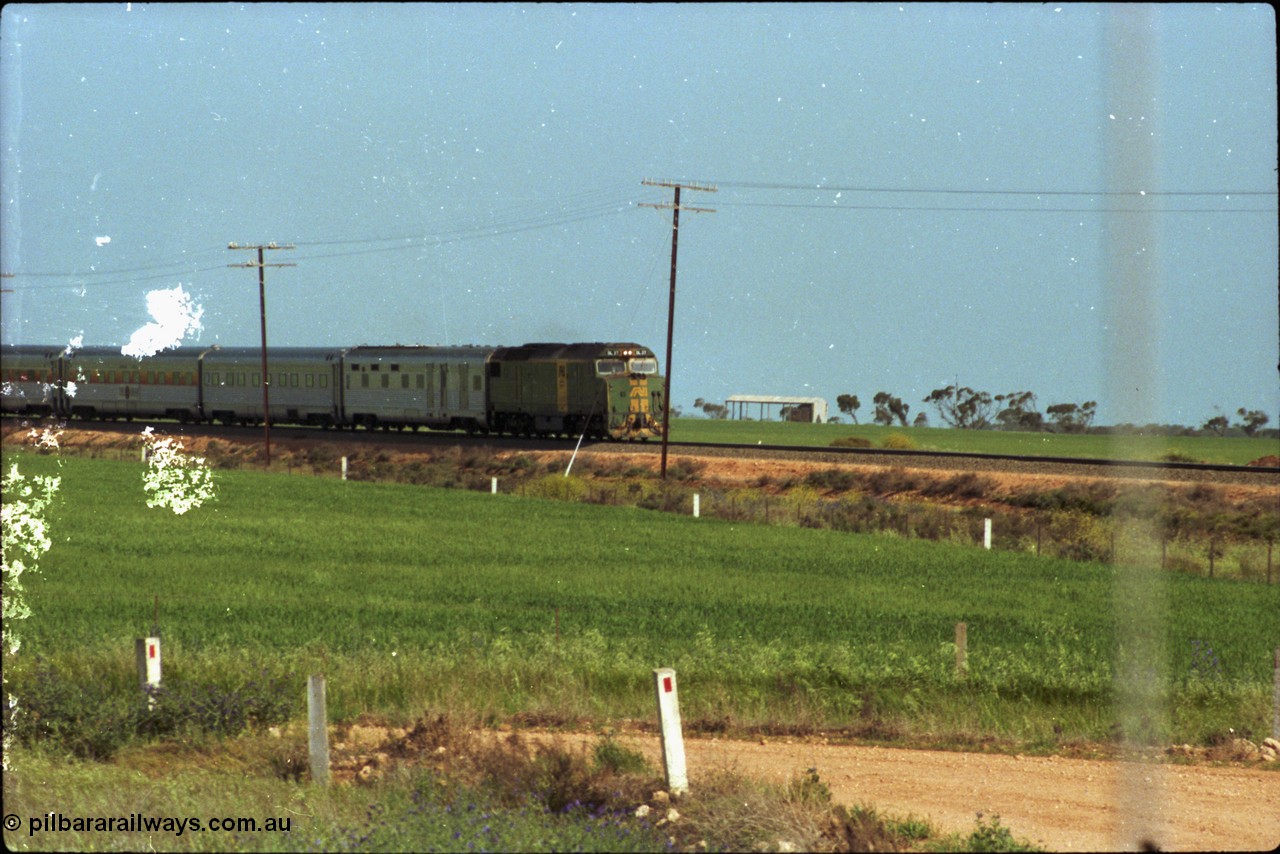 216-02
Long Plains, the down passenger train to Alice Springs 'The Ghan' on approach with power from an AN livered DL class DL 37 Clyde Engineering EMD model AT42C serial 88-1245.
Keywords: DL-class;DL49;Clyde-Engineering-Kelso-NSW;EMD;AT42C;89-1268;