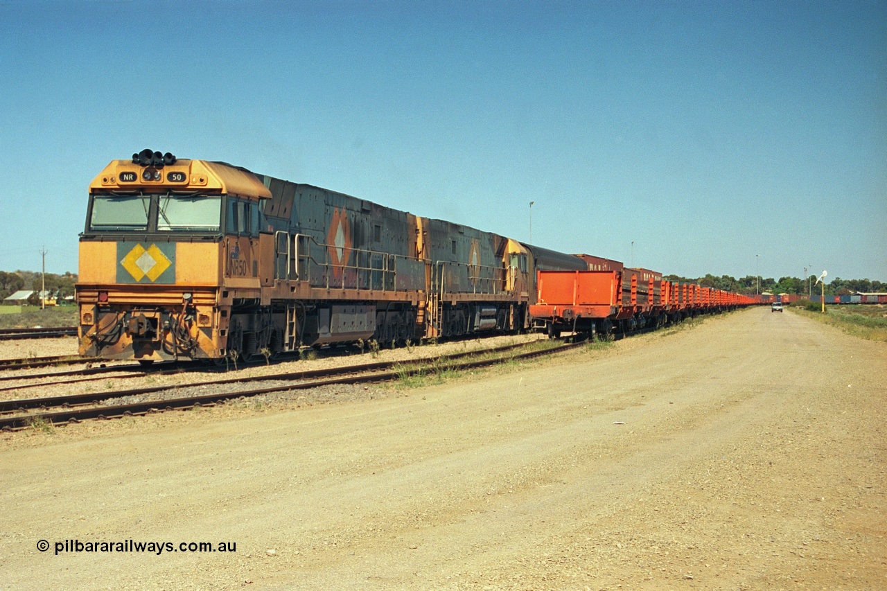 244-01
Port Augusta yard, an SP service waits for departure time next to a rack or rail transport waggons for the Darwin line construction headed up by NR class NR 50, a Goninan built GE Cv40-9i model, serial 7250-08/97-252.
Keywords: NR-class;NR50;Goninan;GE;Cv40-9i;7250-08/97-252;