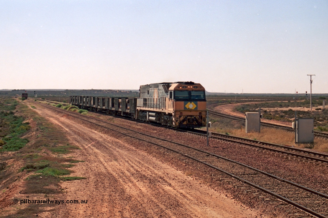 244-11
Port Augusta, Spencer Junction NR class NR 22 leads an UP short four waggon steel train off the Whyalla line. NR 22 is a Goninan built GE model Cv40-9i serial 7250-04/97-224.
