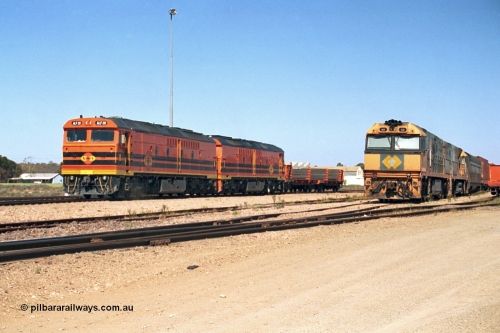 244-04
Port Augusta yard, a pair of ALF class units on the Darwin line construction shunt a rail transport waggon as an SP service wait for departure time with a pair of NR class units. ALF 20 and ALF 18 are both Morrison Knudsen rebuilds, model JT26C-2M serials 94-AN-020 and 94-AN-018.
Keywords: ALF-class;ALF18;ALF20;MKA;EMD;JT26C-2M;94-AN-018;94-AN-020;rebuild;AL-class;Clyde-Engineering;EMD;JT26C;