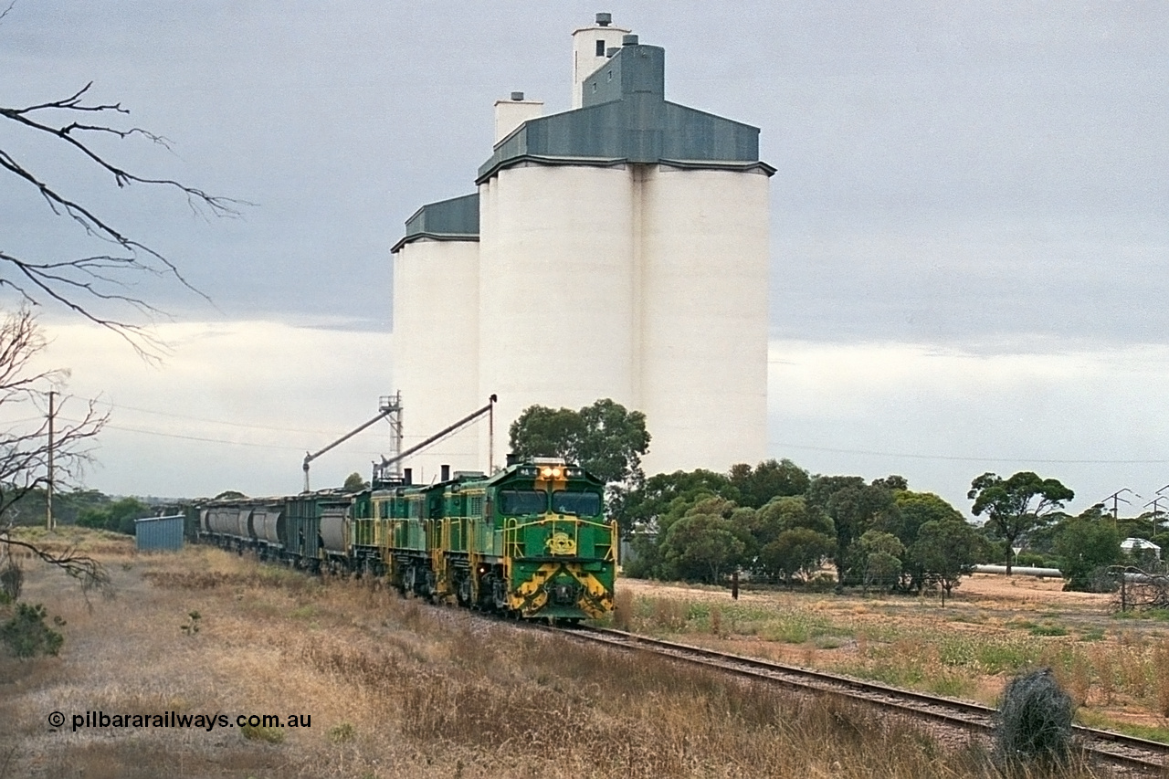 245-26
Yaninee, empty grain train behind a trio of former Australian National Co-Co locomotives with rebuilt former AE Goodwin ALCo model DL531 830 class ex 839, serial no. 83730, rebuilt by Port Augusta Workshops to DA class, leading two AE Goodwin ALCo model DL531 830 class units 842, serial no. 84140 and 851 serial no. 84137, 851 having been on the Eyre Peninsula since delivered in 1962, runs through express on the mainline. 7th April, 2003.
Keywords: DA-class;DA4;83730;Port-Augusta-WS;ALCo;DL531G/1;830-class;839;rebuild;