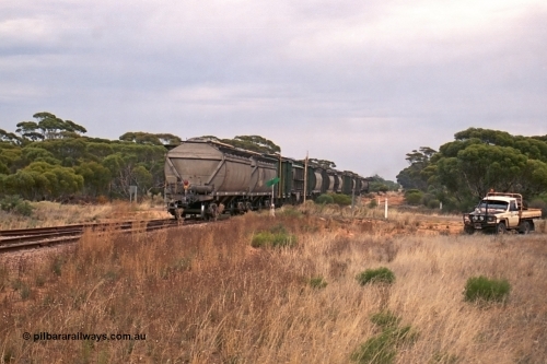 245-29
Yaninee, trailing view of an empty grain train as it trundles over Hunt Terrace with its motely collection of grain waggons as it runs 'express' through Yaninee. 7th April, 2003.
