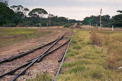 245-32
Minnipa looking in the down direction along the mainline across Burgoyne Terrace towards Poochera with goods siding #2 points and switch stand. April 7, 2003.
