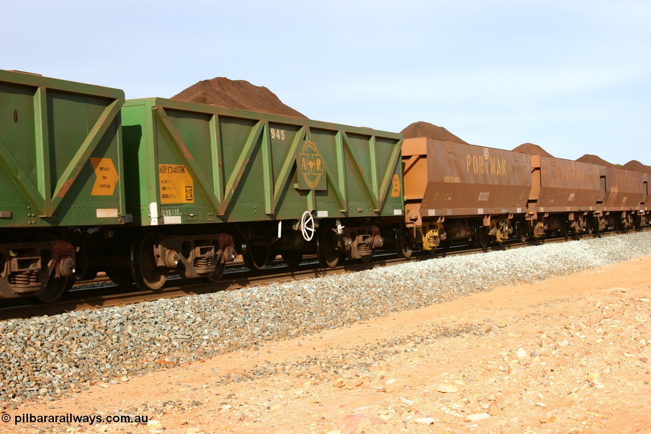 060531 5009
Binduli, AOPY 34079, fleet number 945, one of seventy ex ANR coal waggons rebuilt from AOKF type by Bluebird Engineering SA in service with ARG on Koolyanobbing iron ore trains. They used to be three metres longer and originally built by Metropolitan Cammell Britain as GB type in 1952-55, seen here in the consist with sister waggons and WOE type waggons, on a loaded train bound for West Kalgoorlie, 31st May 2006.
Keywords: AOPY-type;AOPY34079;Bluebird-Engineering-SA;Metropolitan-Cammell-Britain;GB-type;