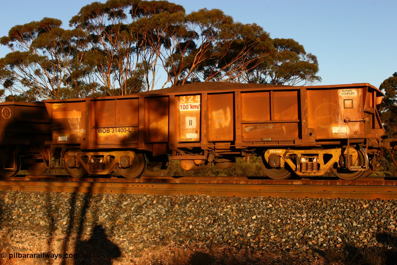 070530 9591
WOB type iron ore waggon WOB 31400 is one of a batch of twenty five built by Comeng WA between 1974 and 1975 and converted from Mt Newman high sided waggons by WAGR Midland Workshops with a capacity of 67 tons with fleet number 324 for Koolyanobbing iron ore operations, but purchased by WAGR. This waggon is one of the 15 converted to WSM type ballast hoppers by re-fitting the removed top section of the body and fitting bottom discharge doors, converted back to WOB in 1998. The angled lines from this conversion are still visible. Loaded train at Binduli, 30th May 2007.
Keywords: WOB-type;WOB31400;Comeng-WA;WSM-type;Mt-Newman-Mining;