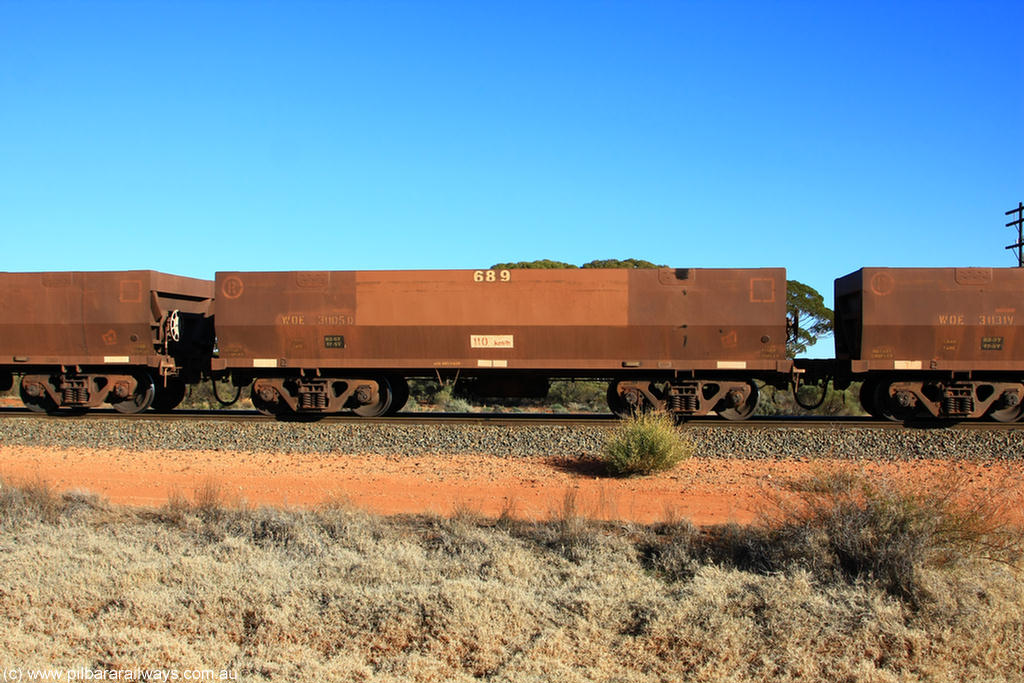 100731 02464
WOE type iron ore waggon WOE 31105 is one of a batch of one hundred and thirty built by Goninan WA between March and August 2001 with serial number 950092-095 and fleet number 689 for Koolyanobbing iron ore operations, on empty train 6418 at Binduli Triangle, 31st July 2010.
Keywords: WOE-type;WOE31105;Goninan-WA;950092-095;