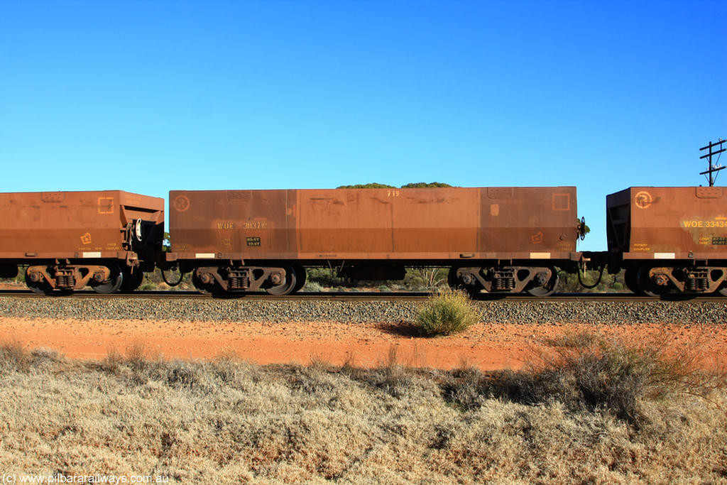 100731 02482
WOE type iron ore waggon WOE 31137 is one of a batch of one hundred and thirty built by Goninan WA between March and August 2001 with serial number 950092-127 and fleet number 719 for Koolyanobbing iron ore operations, on empty train 6418 at Binduli Triangle, 31st July 2010.
Keywords: WOE-type;WOE31137;Goninan-WA;950092-127;