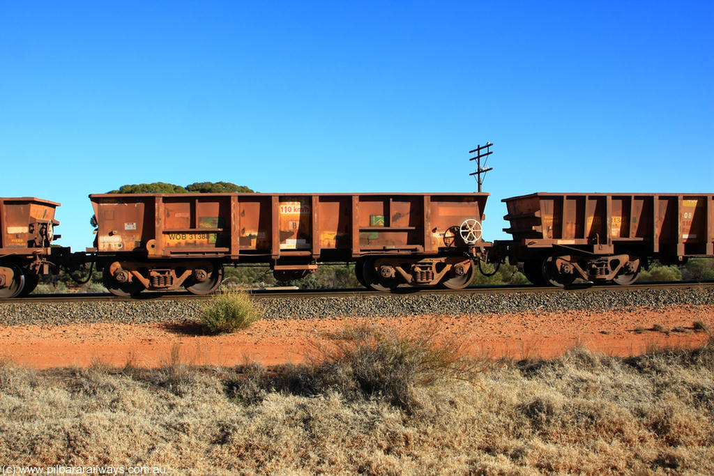 100731 02537
WOB type iron ore waggon WOB 31388 is one of a batch of twenty five built by Comeng WA between 1974 and 1975 and converted from Mt Newman high sided waggons by WAGR Midland Workshops with a capacity of 67 tons with fleet number 313 for Koolyanobbing iron ore operations. This waggon was also converted to a WSM type ballast hopper by re-fitting the cut down top section and having bottom discharge doors fitted, converted back to WOB in 1998, on empty train 6418 at Binduli Triangle, 31st July 2010.
Keywords: WOB-type;WOB31388;Comeng-WA;WSM-type;Mt-Newman-Mining;