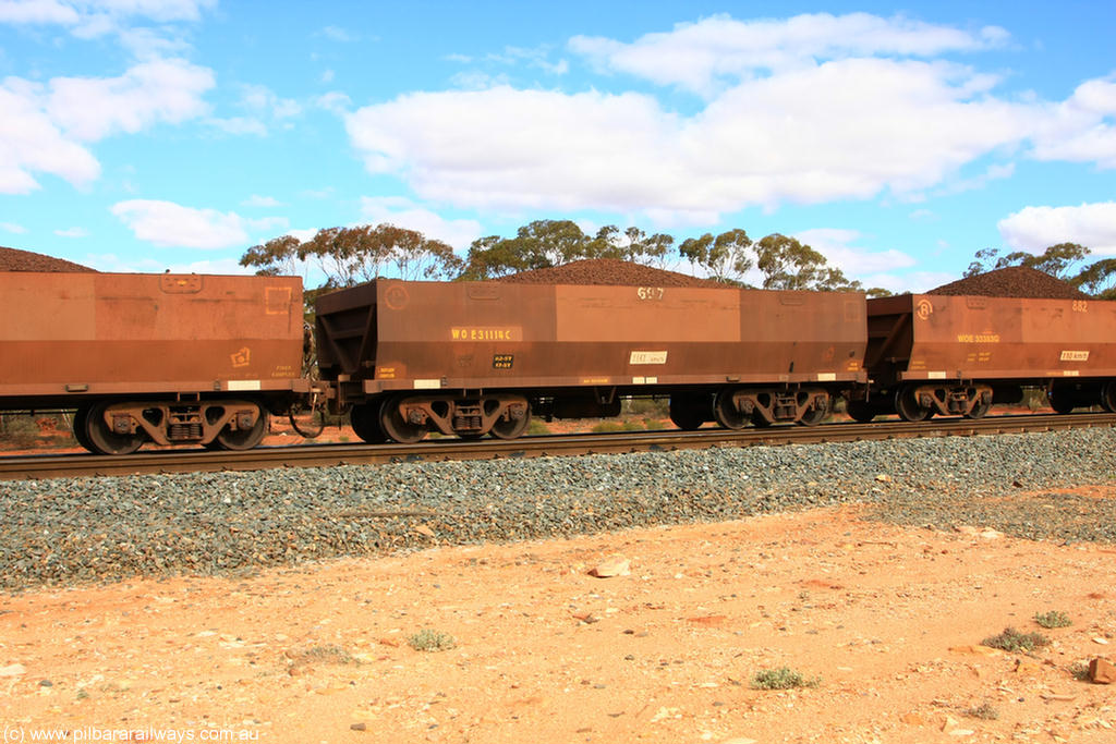 100731 02836
WOE type iron ore waggon WOE 31114 is one of a batch of one hundred and thirty built by Goninan WA between March and August 2001 with serial number 950092-104 and fleet number 697 for Koolyanobbing iron ore operations, on loaded train 7415 at Binduli Triangle, 31st July 2010.
Keywords: WOE-type;WOE31114;Goninan-WA;950092-104;
