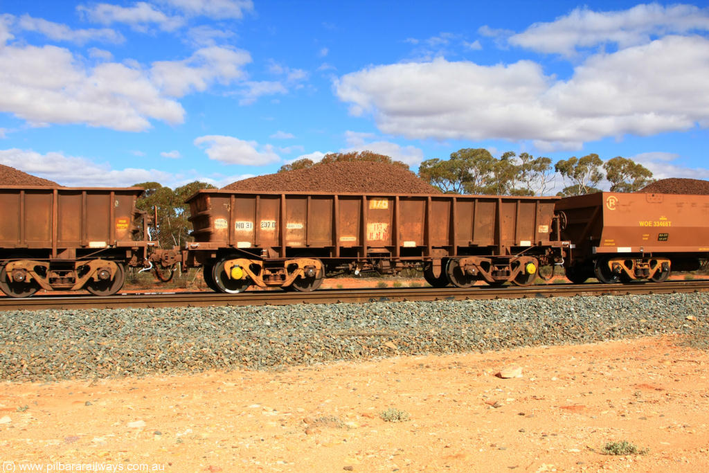 100731 02852
WO type iron ore waggon WO 31297 is one of a batch of fifteen built by WAGR Midland Workshops between July and October 1968 with fleet number 176 for Koolyanobbing iron ore operations, with a 75 ton and 1018 ft³ capacity, on loaded train 7415 at Binduli Triangle, 31st July 2010. This unit was converted to WOG for gypsum in late 1980s till 1994 when it was re-classed back to WO.
Keywords: WO-type;WO31297;WAGR-Midland-WS;