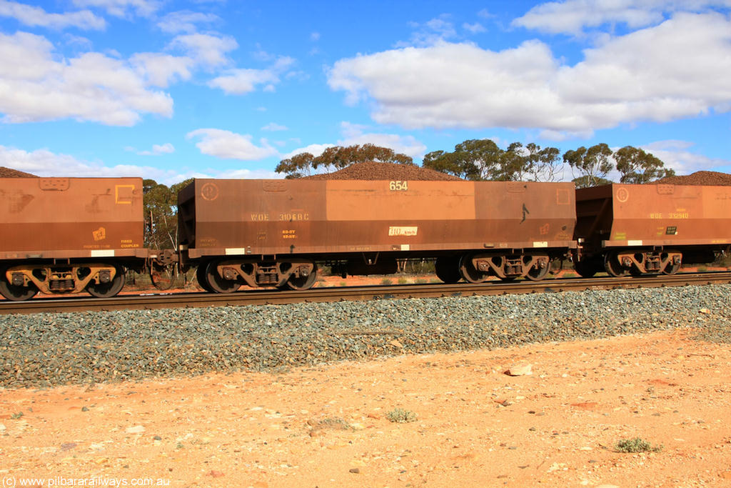 100731 02867
WOE type iron ore waggon WOE 31068 is one of a batch of one hundred and thirty built by Goninan WA between March and August 2001 with serial number 950092-058 and fleet number 654 for Koolyanobbing iron ore operations, on loaded train 7415 at Binduli Triangle, 31st July 2010.
Keywords: WOE-type;WOE31068;Goninan-WA;950092-058;