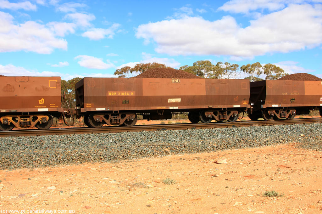 100731 02873
WOE type iron ore waggon WOE 31064 is one of a batch of one hundred and thirty built by Goninan WA between March and August 2001 with serial number 950092-054 and fleet number 650 for Koolyanobbing iron ore operations, on loaded train 7415 at Binduli Triangle, 31st July 2010.
Keywords: WOE-type;WOE31064;Goninan-WA;950092-054;