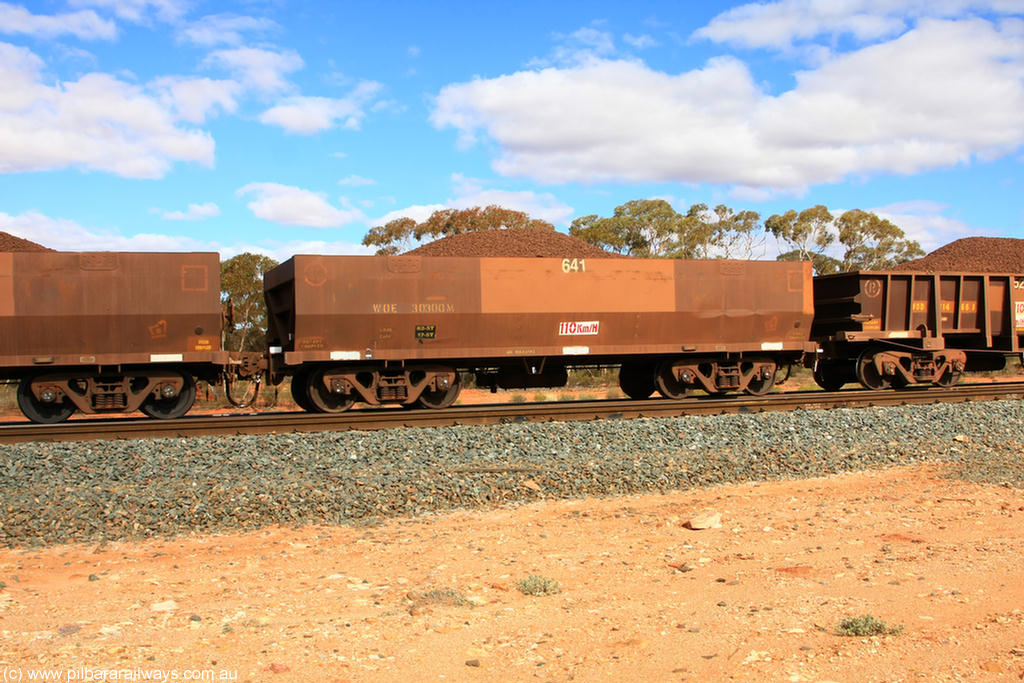 100731 02874
WOE type iron ore waggon WOE 30300 is one of a batch of one hundred and thirty built by Goninan WA between March and August 2001 with serial number 950092-050 and fleet number 641 for Koolyanobbing iron ore operations, on loaded train 7415 at Binduli Triangle, 31st July 2010.
Keywords: WOE-type;WOE30300;Goninan-WA;950092-050;