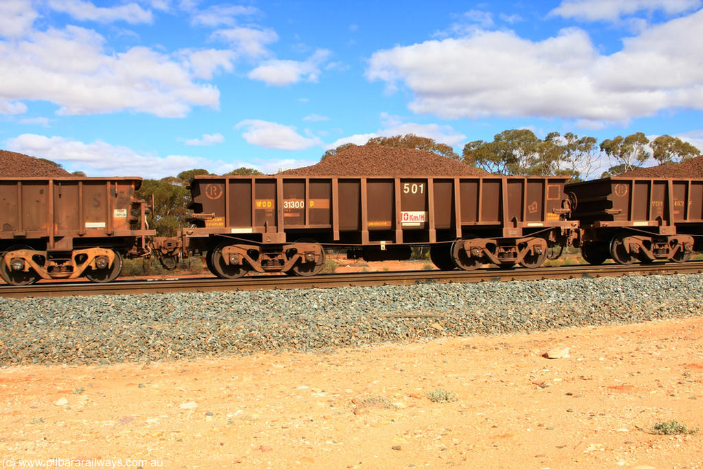 100731 02877
WOD type iron ore waggon WOD 31300 is one of a batch of sixty two built by Goninan WA between April and August 2000 with serial number 950086-011 and fleet number 501 for Koolyanobbing iron ore operations with a 75 ton capacity and a replacement for a WO type waggon number, for Portman Mining to cart their Koolyanobbing iron ore to Esperance, on loaded train 7415 at Binduli Triangle, 31st July 2010.
Keywords: WOD-type;WOD31300;Goninan-WA;950086-011;