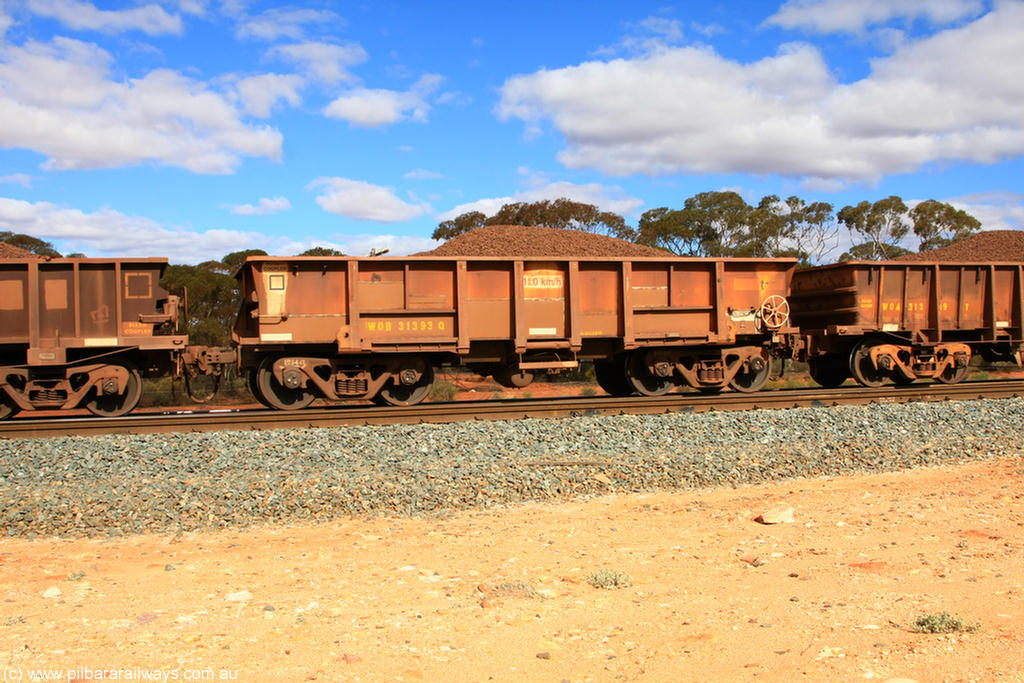 100731 02880
WOB type iron ore waggon WOB 31393 is one of a batch of twenty five built by Comeng WA between 1974 and 1975 and converted from Mt Newman high sided waggons by WAGR Midland Workshops with a capacity of 67 tons with fleet number 318 for Koolyanobbing iron ore operations. This waggon was also converted to a WSM type ballast hopper by re-fitting the cut down top section and having bottom discharge doors fitted, converted back to WOB in 1998, on loaded train 7415 at Binduli Triangle, 31st July 2010.
Keywords: WOB-type;WOB31393;Comeng-WA;WSM-type;Mt-Newman-Mining;