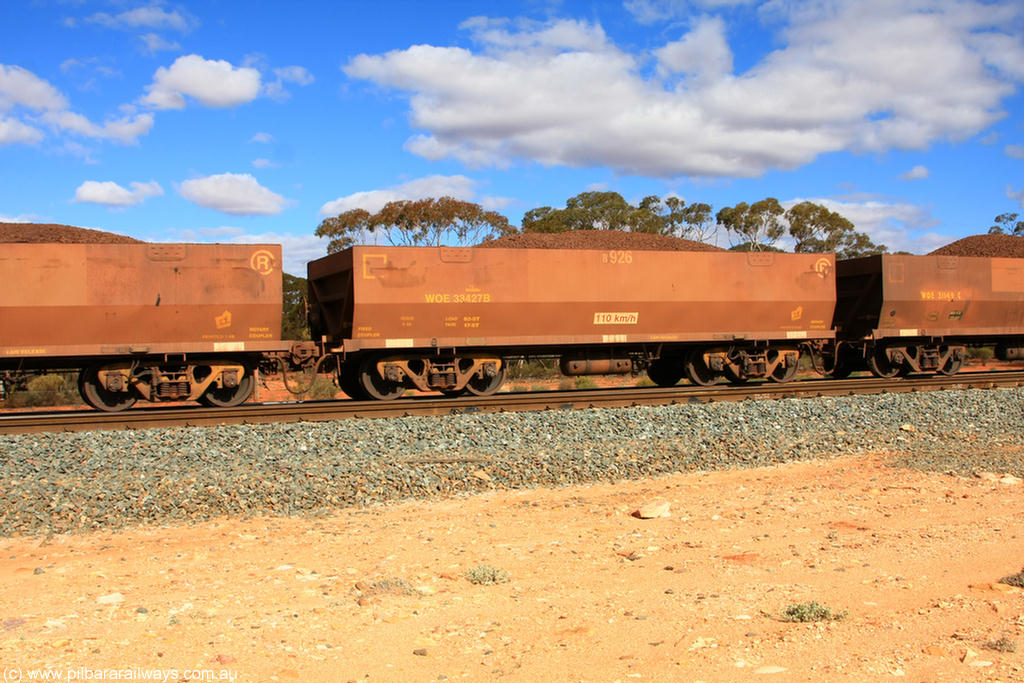 100731 02926
WOE type iron ore waggon WOE 33427 is one of a batch of one hundred and forty one built by United Group Rail WA between November 2005 and April 2006 with serial number 950142-132 and fleet number 8926 for Koolyanobbing iron ore operations, on loaded train 7415 at Binduli Triangle, 31st July 2010.
Keywords: WOE-type;WOE33427;United-Group-Rail-WA;950142-132;