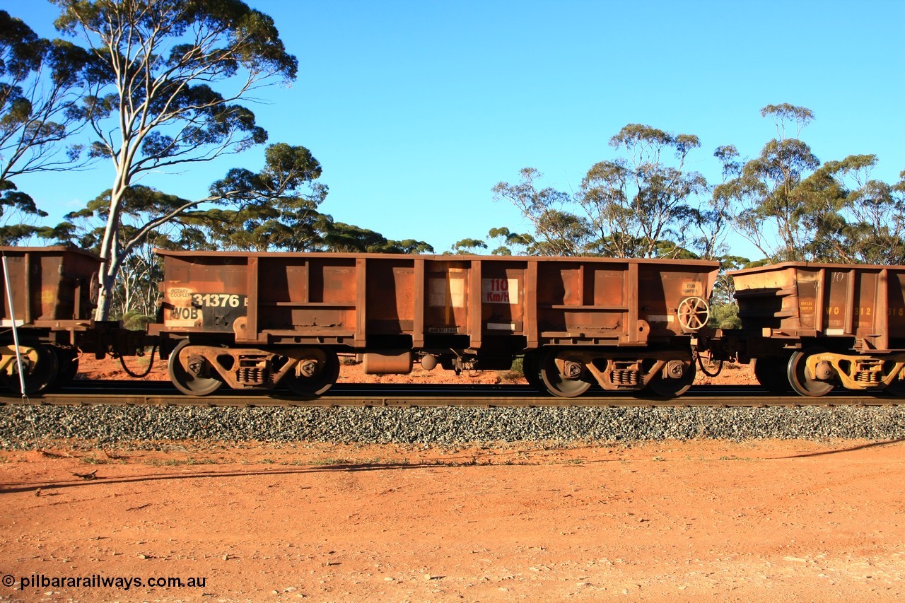 100731 03117
WOB type iron ore waggon WOB 31376 is leader of a batch of twenty five built by Comeng WA between 1974 and 1975 and converted from Mt Newman high sided waggons by WAGR Midland Workshops with a capacity of 67 tons with fleet number 301 for Koolyanobbing iron ore operations., empty train arriving at Binduli Triangle, 31st July 2010.
Keywords: WOB-type;WOB31376;Comeng-WA;Mt-Newman-Mining;
