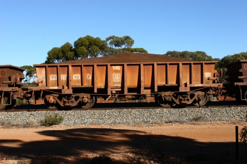 060528 4596
WO type iron ore waggon WO 31260 is one of a batch of sixty two built by Goninan WA between April and August 2000 with serial number 950086-010 and fleet number 146 for Koolyanobbing iron ore operations, and is a Goninan built replacement WO type waggon that replaces the original WAGR built WO type waggon with the newer style WOD type and has square features opposed to the curved ones as on the original WO class, seen here loaded with fines ore on train 413 at Bonnie Vale, May 28, 2006.
Keywords: WO-type;WO31260;Goninan-WA;950086-010;