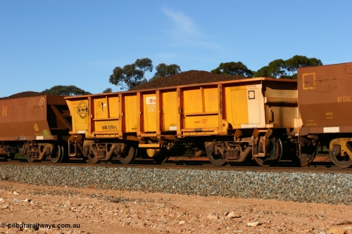 060530 4971
WOB type iron ore waggon WOB 31395 is one of a batch of twenty five built by Comeng WA between 1974 and 1975 and converted from Mt Newman high sided waggons by WAGR Midland Workshops with a capacity of 67 tons with fleet number 325 for Koolyanobbing iron ore operations. This waggon was also converted to a WSM type ballast hopper by re-fitting the cut down top section and having bottom discharge doors fitted, converted back to WOB in 1997, and later converted to a WSM type ballast hopper, then back to its current guise, and this is the first one to be repainted in ARG yellow, shows capacity of 32M³, loaded with lump ore, Binduli 30th May 2006.
Keywords: WOB-type;WOB31395;Comeng-WA;WSM-type;Mt-Newman-Mining;
