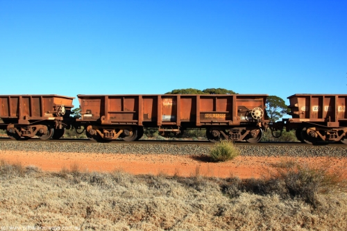 100731 02439
WOB type iron ore waggon WOB 31386 is one of a batch of twenty five built by Comeng WA between 1974 and 1975 and converted from Mt Newman high sided waggons by WAGR Midland Workshops with a capacity of 67 tons with fleet number 311 for Koolyanobbing iron ore operations. This waggon was also converted to a WSM type ballast hopper by re-fitting the cut down top section and having bottom discharge doors fitted, converted back to WOB in 1998, on empty train 6418 at Binduli Triangle, July 31, 2010.
Keywords: WOB-type;WOB31386;Comeng-WA;WSM-type;Mt-Newman-Mining;