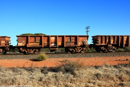 100731 02537
WOB type iron ore waggon WOB 31388 is one of a batch of twenty five built by Comeng WA between 1974 and 1975 and converted from Mt Newman high sided waggons by WAGR Midland Workshops with a capacity of 67 tons with fleet number 313 for Koolyanobbing iron ore operations. This waggon was also converted to a WSM type ballast hopper by re-fitting the cut down top section and having bottom discharge doors fitted, converted back to WOB in 1998, on empty train 6418 at Binduli Triangle, July 31, 2010.
Keywords: WOB-type;WOB31388;Comeng-WA;WSM-type;Mt-Newman-Mining;